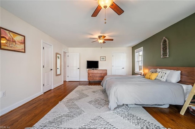 bedroom featuring a ceiling fan, baseboards, and wood finished floors