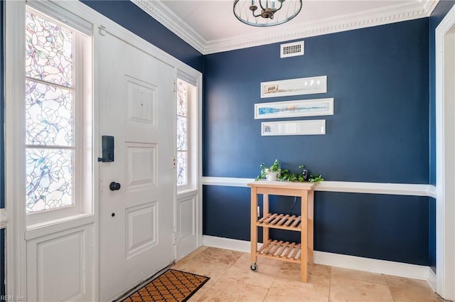 foyer featuring visible vents, plenty of natural light, and crown molding