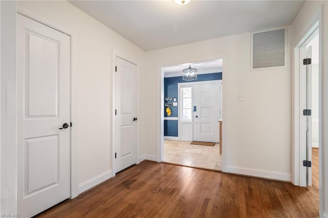 interior space featuring visible vents, baseboards, and wood finished floors