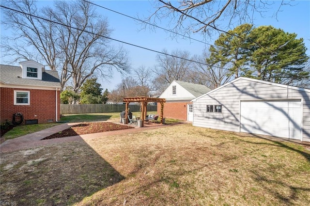 view of yard featuring a garage, a pergola, an outdoor structure, and fence