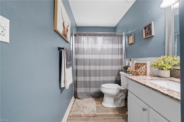 full bathroom with a shower with shower curtain, toilet, wood finished floors, and vanity