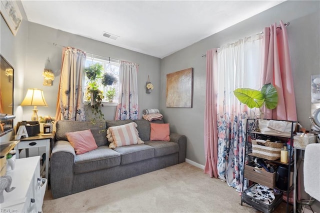 carpeted living area with baseboards and visible vents