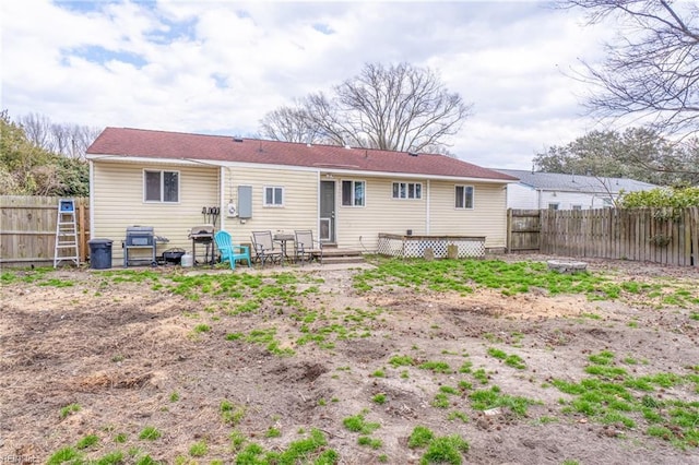 back of house with entry steps and a fenced backyard