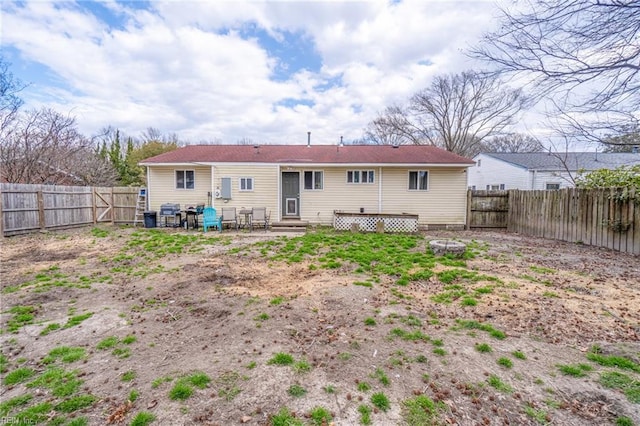 rear view of property featuring a fenced backyard and entry steps