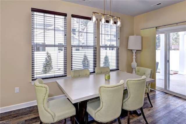 dining room with a wealth of natural light, baseboards, and dark wood-style flooring