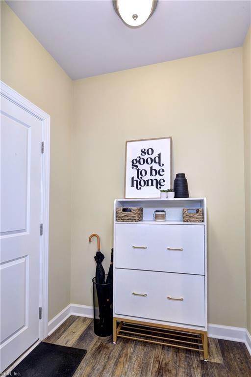 interior space with baseboards and dark wood finished floors