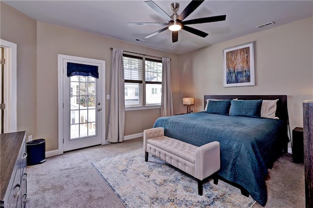 carpeted bedroom featuring visible vents, baseboards, ceiling fan, and access to outside