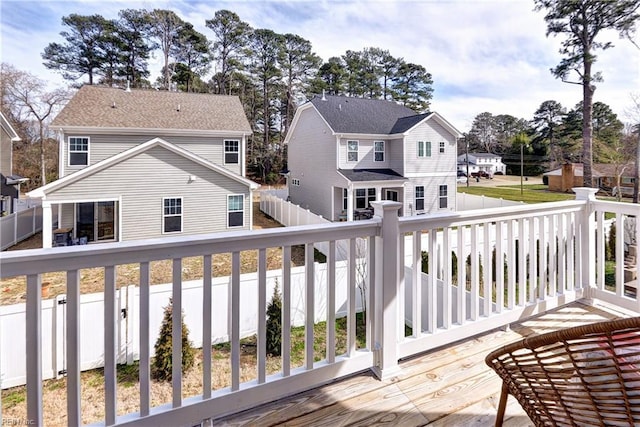 wooden deck featuring a residential view and fence