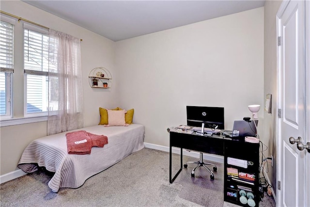 carpeted bedroom featuring baseboards