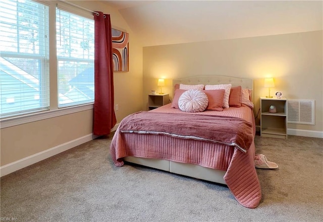 carpeted bedroom featuring visible vents, multiple windows, and baseboards