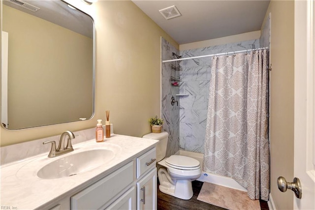 bathroom featuring vanity, toilet, a shower with curtain, and visible vents