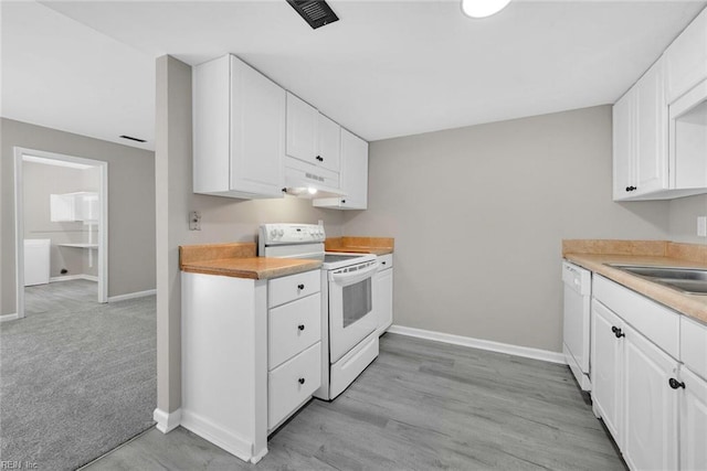 kitchen with under cabinet range hood, white appliances, white cabinetry, and light countertops