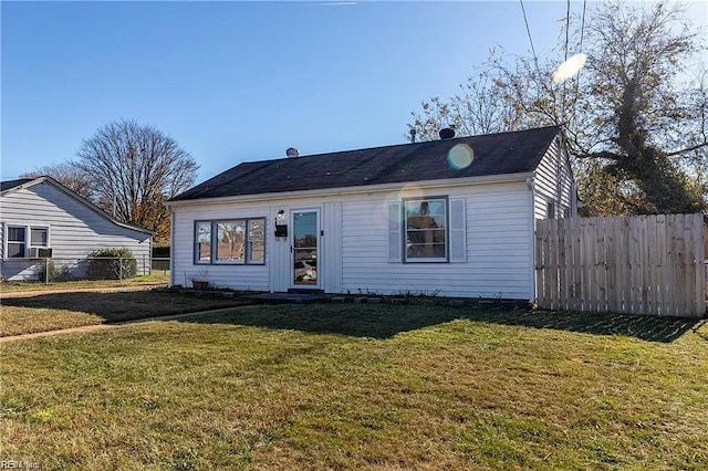 view of front of home featuring a front yard and fence