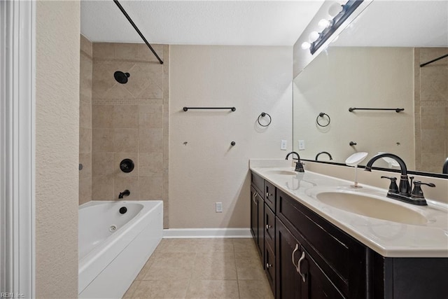 bathroom with a sink, baseboards, shower / tub combination, and tile patterned flooring