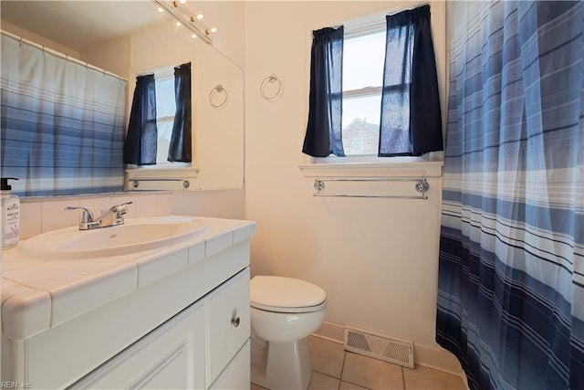 bathroom with vanity, a shower with curtain, visible vents, tile patterned floors, and toilet