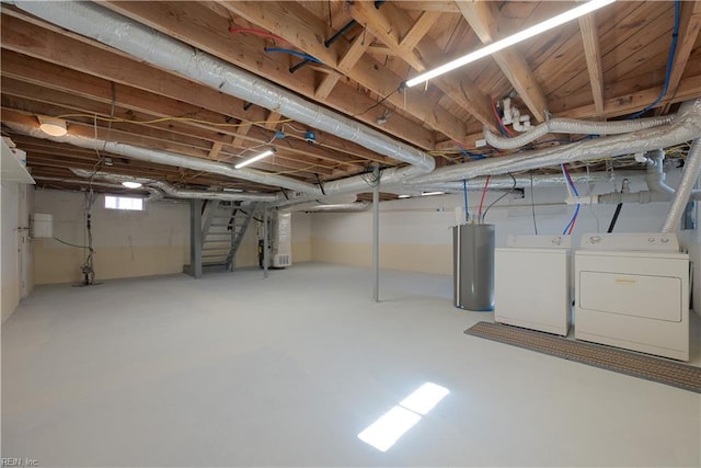 basement featuring washer and dryer, stairway, and water heater