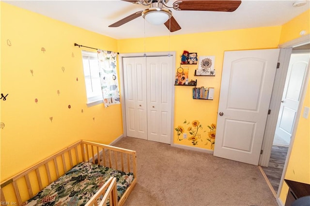 bedroom with a closet, baseboards, ceiling fan, and carpet flooring