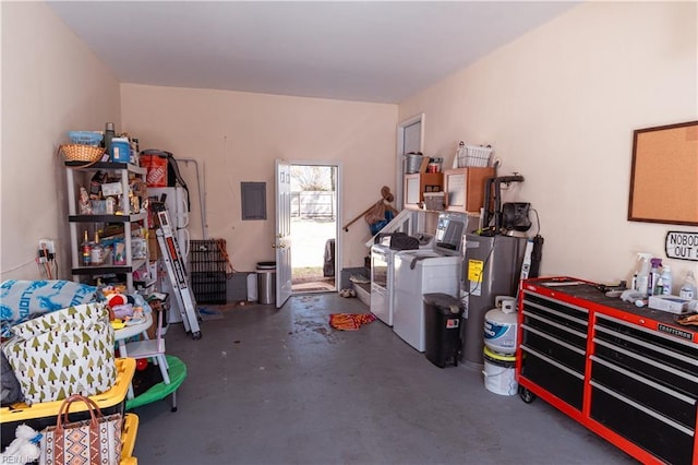 garage featuring washing machine and clothes dryer and electric panel