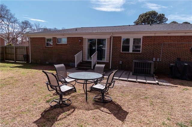 back of house featuring brick siding, fence, entry steps, cooling unit, and crawl space