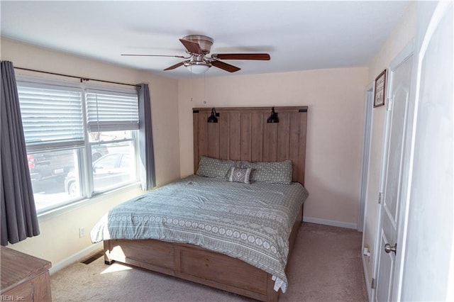 bedroom featuring a ceiling fan, carpet, and baseboards