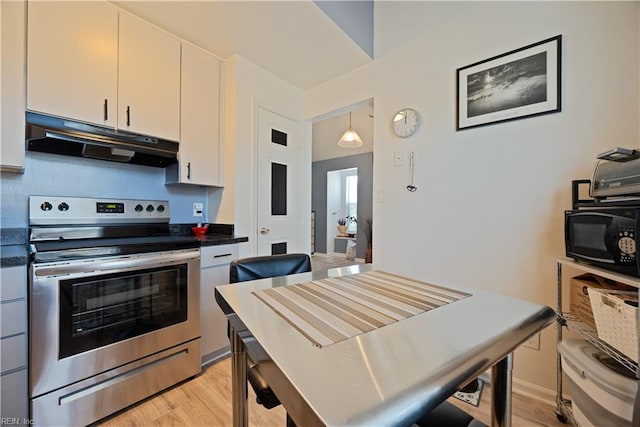 kitchen with stainless steel range with electric stovetop, light wood-style flooring, under cabinet range hood, dark countertops, and black microwave