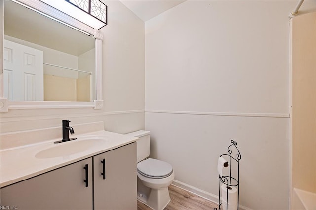 full bathroom with vanity, toilet, wood finished floors, and a shower