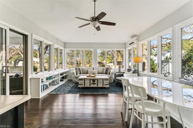 sunroom with ceiling fan, a wall unit AC, and vaulted ceiling