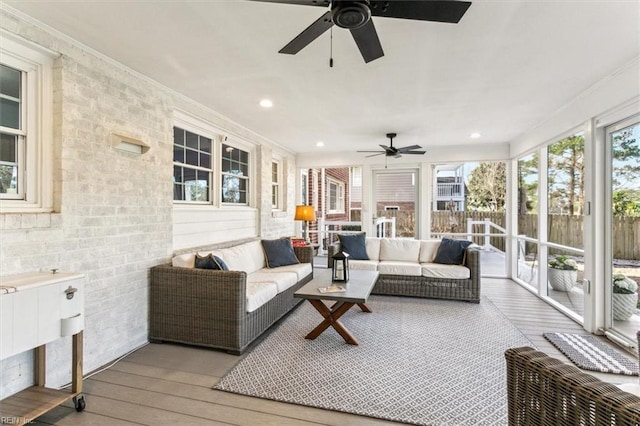 sunroom with a ceiling fan