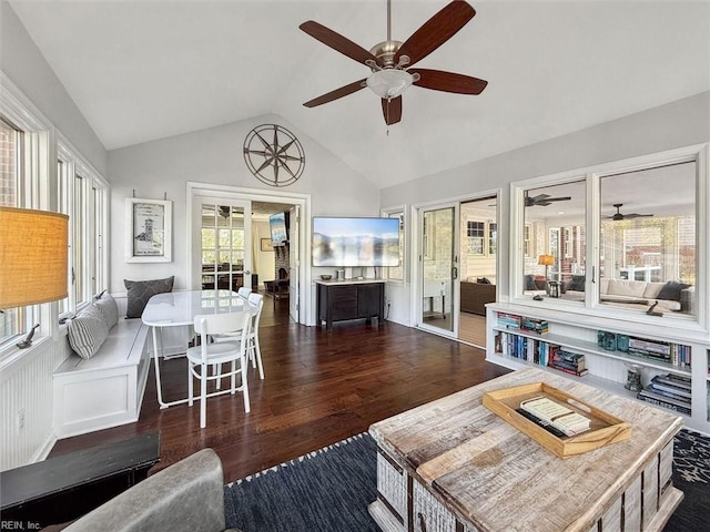 living area featuring ceiling fan, lofted ceiling, wood finished floors, and a sunroom