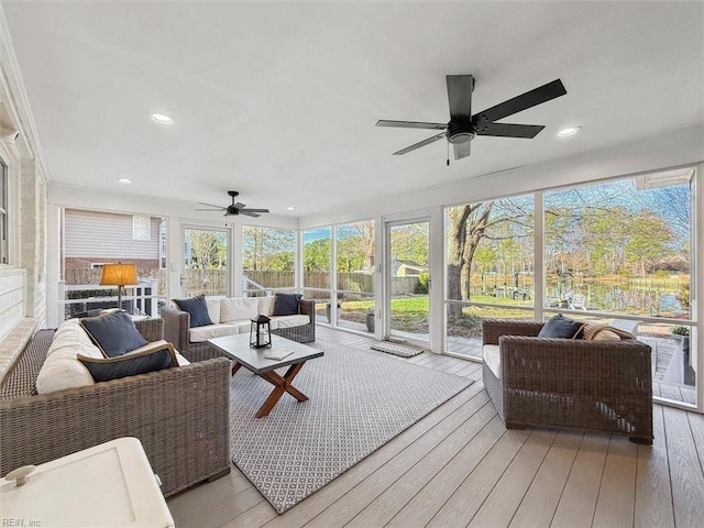 sunroom featuring a ceiling fan