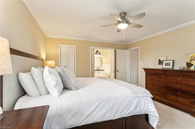 bedroom featuring a ceiling fan, carpet, ensuite bath, and crown molding