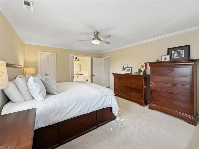 carpeted bedroom featuring visible vents, ensuite bath, ceiling fan, and ornamental molding