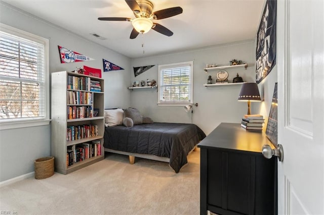 bedroom with a ceiling fan, light colored carpet, and visible vents