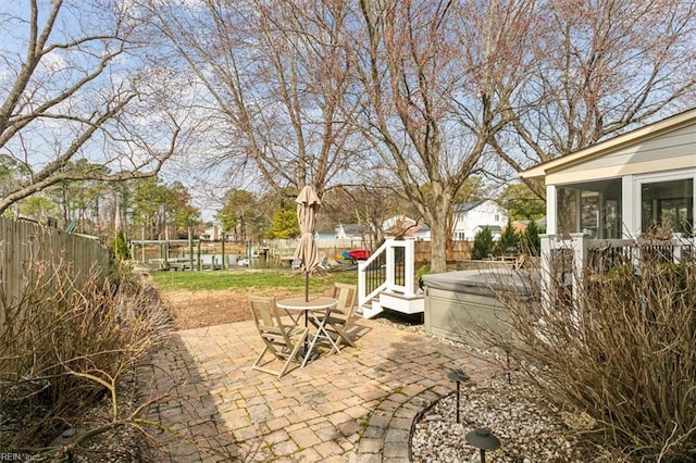 view of patio / terrace with a fenced backyard and a sunroom