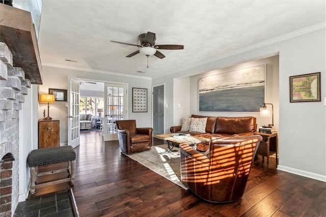 living area featuring hardwood / wood-style flooring, french doors, crown molding, a fireplace, and baseboards