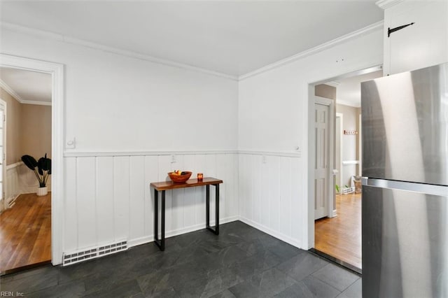 spare room with visible vents, wainscoting, and ornamental molding