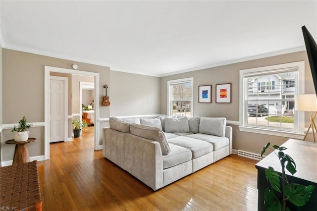 living room featuring visible vents, crown molding, baseboards, and wood finished floors