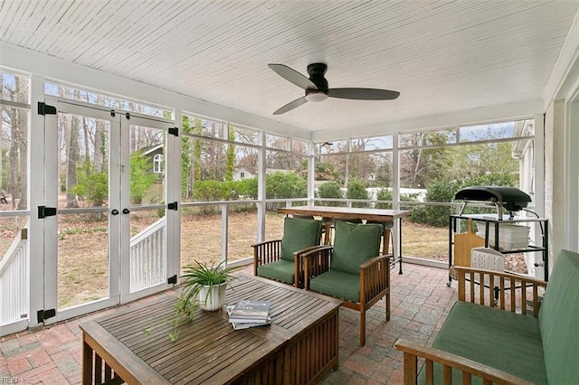 sunroom / solarium with wood ceiling and ceiling fan