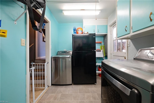 kitchen with washer and clothes dryer and freestanding refrigerator