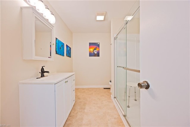 bathroom featuring visible vents, a shower stall, baseboards, toilet, and vanity