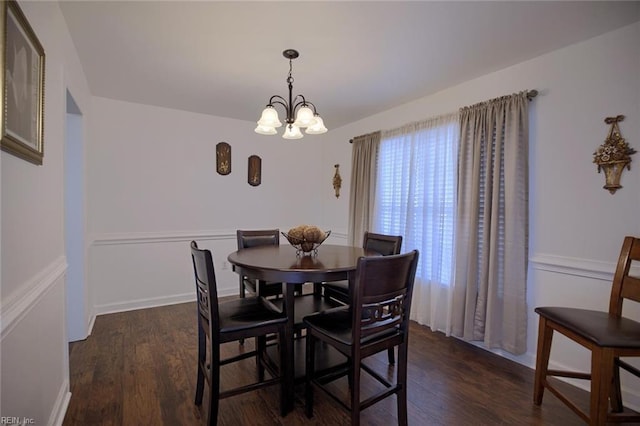 dining space featuring a notable chandelier and wood finished floors