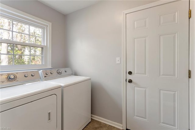 laundry area with laundry area, separate washer and dryer, and baseboards