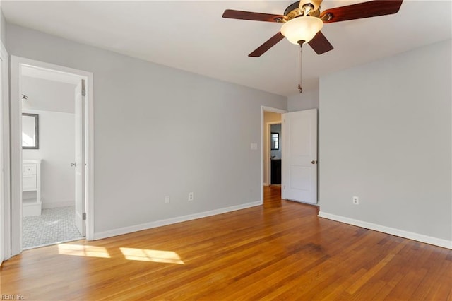 unfurnished room with ceiling fan, baseboards, and light wood-style flooring