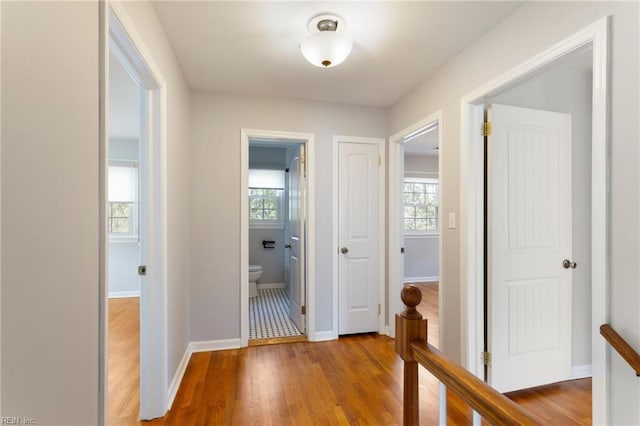 hall featuring baseboards and wood finished floors