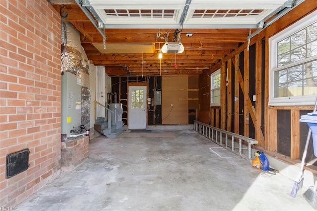 garage with electric panel, a garage door opener, and water heater