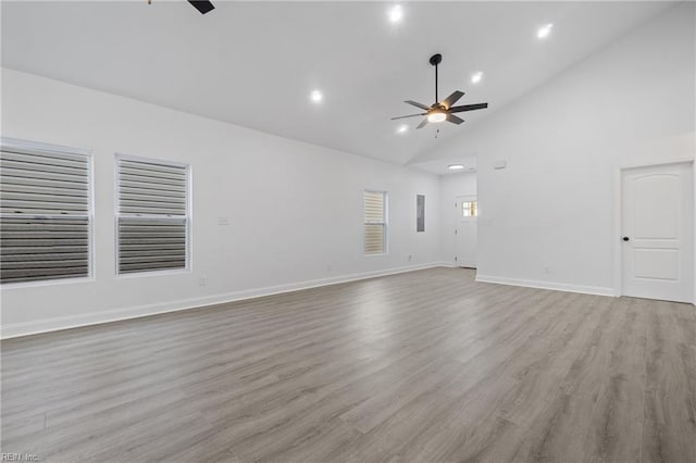 unfurnished living room with high vaulted ceiling, a ceiling fan, wood finished floors, recessed lighting, and baseboards