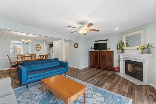 living room with visible vents, baseboards, and wood finished floors