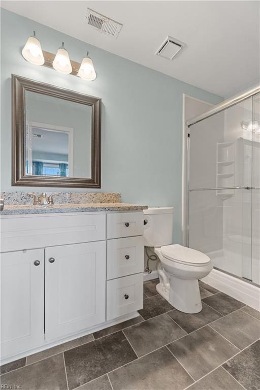 bathroom featuring visible vents, a stall shower, and toilet