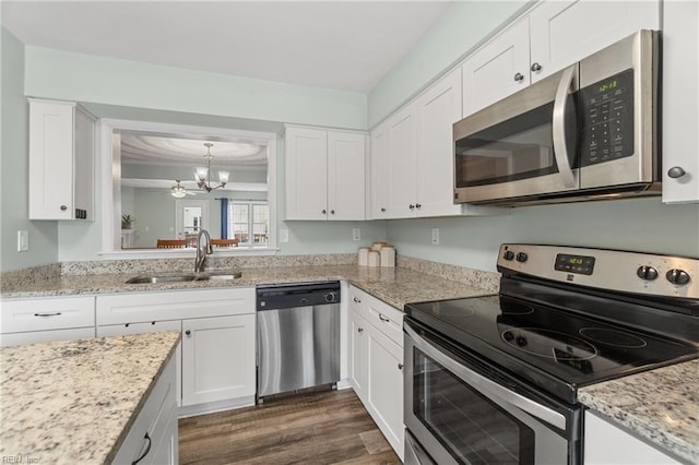 kitchen with a sink, stainless steel appliances, and white cabinetry