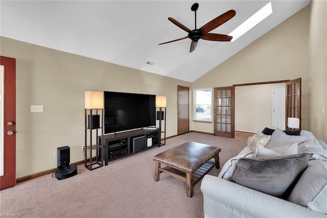 living room with baseboards, carpet floors, high vaulted ceiling, and a ceiling fan